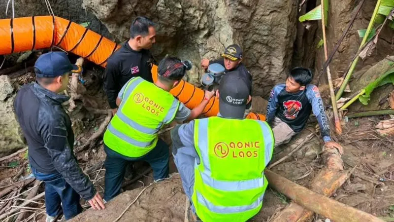 Rescuers race to free seven people trapped in flooded Laos cave